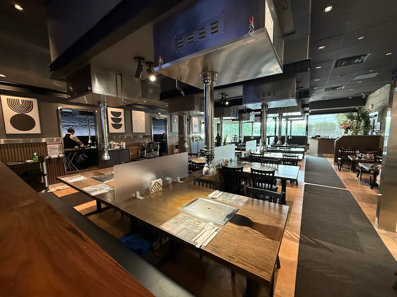 Dining room at Piggy Ssonday with grill-equipped tables and overhead vents